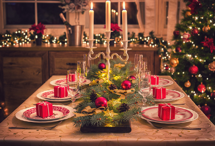 Elegant table setting for Christmas dinner with candles and Christmas decorations