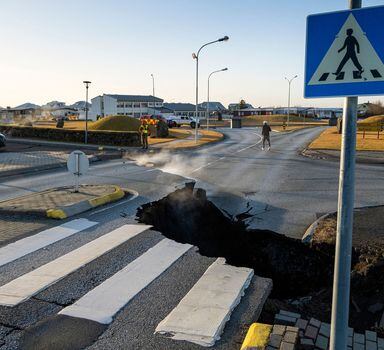 TOPSHOT - This photo taken on November 13, 2023 shows a crack cutting across the main road in Grindavik, southwestern Iceland following earthquakes. The southwestern town of Grindavik -- home to around 4,000 people -- was evacuated in the early hours of November 11 after magma shifting under the Earth's crust caused hundreds of earthquakes in what experts warned could be a precursor to a volcanic eruption.  The seismic activity damaged roads and buildings in the town situated 40 kilometres (25 miles) southwest of the capital Reykjavik, an AFP journalist saw. (Photo by Kjartan TORBJOERNSSON / AFP) / Iceland OUT