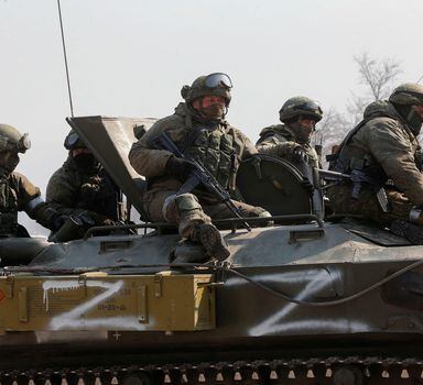 Service members of pro-Russian troops are seen atop of an armoured vehicle with symbols "Z" painted on its side in the course of Ukraine-Russia conflict in the besieged southern port city of Mariupol, Ukraine March 24, 2022. REUTERS/Alexander Ermochenko