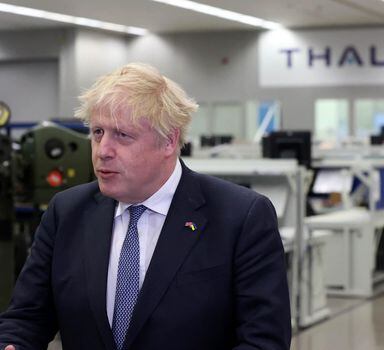 Britain's Prime Minister Boris Johnson reacts during a visit to Thales weapons manufacturer in Belfast on May 16, 2022. - UK Prime Minister Boris Johnson faced demands for action from Northern Irish political parties Monday as he visited the province amid an increasingly bitter dispute over post-Brexit trade which is currently preventing power-sharing there. (Photo by Liam McBurney / POOL / AFP)