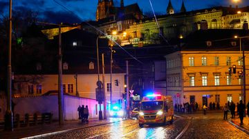 An ambulance drives towards the building housing the Philosophical Faculty of Charles University in downtown Prague, Czech Republic, Thursday, Dec. 21, 2023. Czech police say a shooting in downtown Prague has killed an unspecified number of people and wounded others. (AP Photo/Petr David Josek)