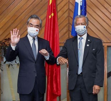 In this photo released by Xinhua News Agency, Secretary-General Pacific Islands Forum Secretariat Henry Puna, right, and visiting Chinese Foreign Minister Wang Yi pose for a photo before their meeting in Suva, Fiji, Sunday, May 29, 2022. (Zhang Yongxing/Xinhua via AP)