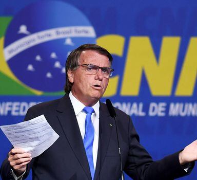 (FILES) In this file photo taken on April 26, 2022 Brazilian President Jair Bolsonaro gestures as he speaks during the opening of the XXIII March in Defence of Municipalities in Brasilia. - Brazilian President Jair Bolsonaro has described as "inadmissible" the fact that an 11-year-old girl legally terminated her pregnancy after being raped, in a country where abortion rights are still highly restricted. (Photo by EVARISTO SA / AFP)