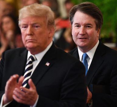 (FILES) In this file photo taken on October 08, 2018 US President Trump (L) during the swearing-in ceremony of Brett Kavanaugh (R) as Associate Justice of the US Supreme Court at the White House in Washington, DC. - The US Supreme Court on June 24, 2022 struck down the right to abortion in a seismic ruling that shredded five decades of constitutional protections and prompted several right-leaning states to impose immediate bans on the procedure. "God made the decision," said former Republican president Donald Trump in praising the court's ruling. The ruling was made possible by Trump's nomination of three conservative justices -- Neil Gorsuch, Kavanaugh and Amy Coney Barrett. (Photo by Brendan Smialowski / AFP)