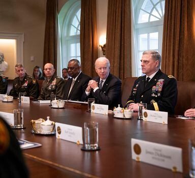 President Joe Biden is flanked by Defense Secretary Lloyd Austin, left, and Gen. Mark Milley, chairman of the Joint Chiefs of Staff, as he meets with military commanders at the White House on Wednesday, April 20, 2022. Reflecting a renewed sense of urgency, Biden announced that the United States would send the Ukrainians $800 million more in military aid.  (Sarahbeth Maney/The New York Times)