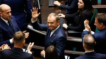 Donald Tusk, center, waves to lawmaker after he was elected as Poland's Prime Minister at the parliament in Warsaw, Poland, Monday Dec. 11, 2023. (AP Photo/Michal Dyjuk)