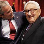 FILE - President George W. Bush, left, stands with former Secretary of State Henry Kissinger after the president spoke about the economy during an addressing before The Economic Club of New York in New York, March 14, 2008. Kissinger, the diplomat with the thick glasses and gravelly voice who dominated foreign policy as the United States extricated itself from Vietnam and broke down barriers with China, died Wednesday, Nov. 29, 2023. He was 100. (AP Photo/Charles Dharapak, File)