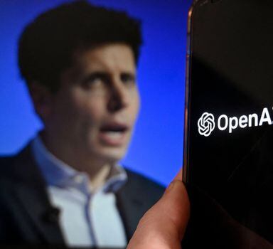 (ILLUSTRATION) This illustration photo produced in Arlington, Virginia on November 20, 2023, shows a smart phone screen displaying the logo of OpenAI juxtaposed with a screen showing a photo of former OpenAI CEO Sam Altman attending the Asia-Pacific Economic Cooperation (APEC) Leaders' Week in San Francisco, California, on November 16, 2023. Hundreds of staff at OpenAI threatened to quit the leading artificial intelligence company on November 20, 2023 and join Microsoft. They would follow OpenAI co-founder Sam Altman, who said he was starting an AI subsidiary at Microsoft following his shock sacking on November 17, 2023 from the company whose ChatGPT chatbot has led the rapid rise of artificial intelligence technology. In a letter, some of OpenAI's most senior staff members threatened to leave the company if the board did not get replaced. Reports said as many as 500 of OpenAI's 770 employees signed the letter. The startup's board sacked Altman on Friday, with US media citing concerns that he was underestimating the dangers of its tech and leading the company away from its stated mission -- claims his successor has denied. (Photo by OLIVIER DOULIERY / AFP)