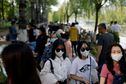 People wearing face masks enjoy the outdoor weather at a park during a five-day Labour Day holiday, amid the coronavirus disease (COVID-19) outbreak in Chaoyang district of Beijing, China May 2, 2022. REUTERS/Carlos Garcia Rawlins