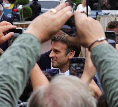 French President Emmanuel Macron greets supporters as he attends to vote in the second round of French parliamentary elections, at a polling station in Le Touquet-Paris-Plage, France, June 19, 2022. REUTERS/Pascal Rossignol