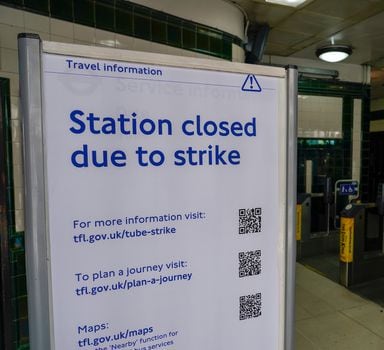 A sign reading 'Station closed due to strike' is placed inside Covent Garden Underground station, in London, Tuesday, June 21, 2022. Tens of thousands of railway workers walked off the job in Britain on Tuesday, bringing the train network to a crawl in the country's biggest transit strike for three decades. (AP Photo/Alberto Pezzali)