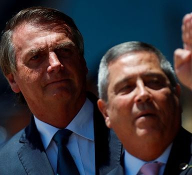 FILE PHOTO: Brazil's President Jair Bolsonaro looks on next to Brazil's Defense Minister Walter Souza Braga Netto during a welcome ceremony to receive the Brazilians and foreigners evacuated from Ukraine during the mission of repatriation, at the Brasilia Air Base, in Brasilia, Brazil March 10, 2022. REUTERS/Adriano Machado/File Photo