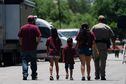 A state trooper escorts a group of family onto the campus of Robb Elementary School in Uvalde, Texas, Wednesday, May 25, 2022. Desperation turned to heart-wrenching sorrow for families of grade schoolers killed after an 18-year-old gunman barricaded himself in their Texas classroom and began shooting, killing at least 19 fourth-graders and their two teachers. (AP Photo/Jae C. Hong)