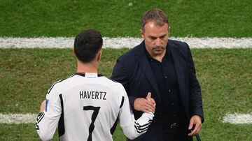 Germany's coach #00 Hans-Dieter Flick (R) shakes hands with Germany's midfielder #07 Kai Havertz at the end of the Qatar 2022 World Cup Group E football match between Costa Rica and Germany at the Al-Bayt Stadium in Al Khor, north of Doha on December 1, 2022. (Photo by FRANCK FIFE / AFP)