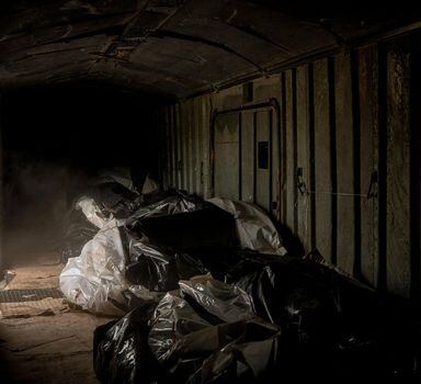 **EDS.: PLEASE NOTE POTENTIALLY OBJECTIONABLE CONTENT.** The bodies of 62 Russian soldiers in bags, stored in a refrigerated train car on the outskirts of Kharkiv, Ukraine, May 29, 2022. Ukrainian authorities have complained that the Kremlin has been reluctant to engage on the subject of repatriating its dead. (Nicole Tung/The New York Times)
