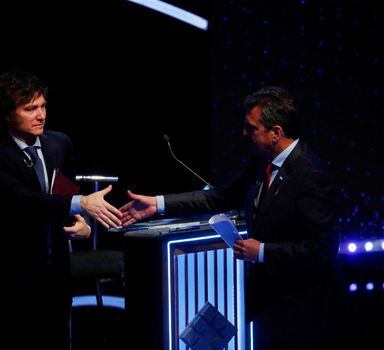 FILE PHOTO: Argentine Presidential candidates Sergio Massa and Javier Milei shake hands as they attend the presidential debate ahead of the October 22 general elections, at the University of Buenos Aires' Law School, Argentina October 8, 2023. REUTERS/Agustin Marcarian/Pool/File Photo