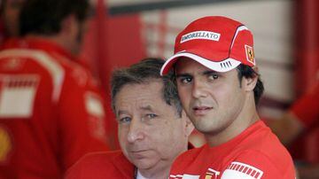 Ferrari Formula One driver Felipe Massa of Brazil and team principal Jean Todt look out from their garage after practice for the U.S. Formula One Grand Prix in Indianapolis June 30, 2006. REUTERS/John Gress (UNITED STATES)