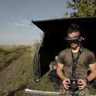 A Ukrainian drone pilot, call sign Darwin, operating a first-person-view, or F.P.V., drone on a test flight near Kupiansk, Ukraine on Aug. 5, 2023. As the war with Russia stretches on, so too does a contest to make more and deadlier flying machines. That means a fight over global electronics supply chains that run through China. (Emile Ducke/The New York Times)