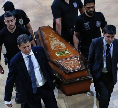 One of the coffins containing human remains found during the search for missing British journalist Dom Phillips and indigenous expert Bruno Pereira in the Amazon forest, is carried upon arrival at the Federal Police hangar in Brasilia on June 16, 2022. - Phillips and Pereira went missing on June 5 in a remote part of the rainforest that is rife with illegal mining, fishing and logging, as well as drug trafficking. On June 15 a suspect in the case took police to a place where he said he had helped bury bodies near the city of Atalaia do Norte, where the two had been headed. Human remains unearthed from the site arrived in Brasilia to be identified by experts. (Photo by Sergio LIMA / AFP)