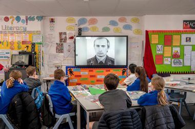 Students at a school in Harsham, England, watch a video about Russian President Vladimir Putin.