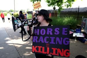 BALTIMORE, MARYLAND - MAY 20: Protesters hold up signs against horse racing outside of Pimlico Race Course ahead of the 148th Running of the Preakness Stakes at on May 20, 2023 in Baltimore, Maryland.   Rob Carr/Getty Images/AFP (Photo by Rob Carr / GETTY IMAGES NORTH AMERICA / Getty Images via AFP)
