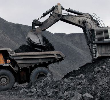 FILE PHOTO: A machine loads a BelAZ dump-body truck with coal at the Chernigovsky opencast colliery, outside the town of Beryozovsky, Kemerovo region, Siberia, Russia, April 4, 2016. REUTERS/Ilya Naymushin/File Photo