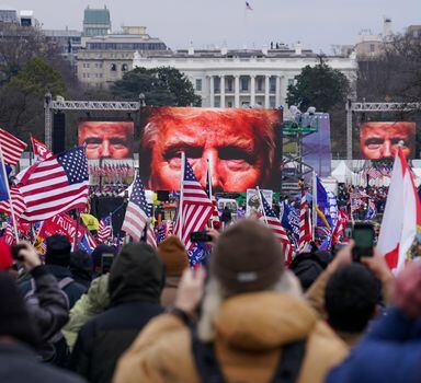 FILE - The face of President Donald Trump appears on large screens as supporters participate in a rally in Washington, Jan. 6, 2021. Members of the House committee investigating the events of Jan. 6 will hold their first prime time hearing Thursday, June 9, 2022, to share what they have uncovered. (AP Photo/John Minchillo, File)
