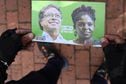 A supporters of Colombian left-wing presidential candidate Gustavo Petro and his running mate Francia Marquez holds a leaftlet depicting them on a street in Bogota, on June 15, 2022, ahead of the week-end's presidential runoff election. - Colombians head to the polls on June 19 for a run-off to choose their new president, either leftist former guerrilla Gustavo Petro or eccentric millionaire construction mogul Rodolfo Hernandez. (Photo by Ophélie LAMARD / AFP)