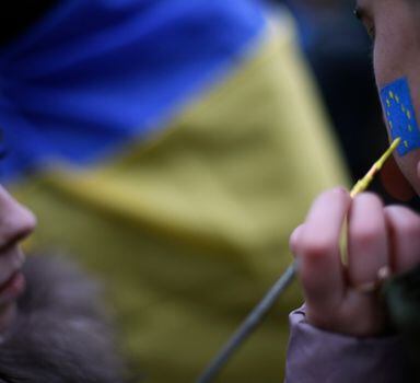 A protester gets his face painted with the colours of the European Union flag during a demonstration in support of EU integration, at Independence Square in Kiev November 28, 2013. Europe's envoys have beaten a path to Viktor Yanukovich's door almost daily for months to clear the way for a historic trade pact between Ukraine and the European Union. But the shock of EU leaders when his government last week pulled the plug on the deal - with only days to go to an EU summit - suggests they gained little insight into the mind of a hard-to-read president who is a riddle both at home and abroad. REUTERS/Stoyan Nenov (UKRAINE  - Tags: POLITICS CIVIL UNREST)