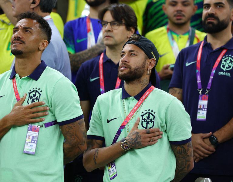 Soccer Football - FIFA World Cup Qatar 2022 - Group G - Cameroon v Brazil - Lusail Stadium, Lusail, Qatar - December 2, 2022 Brazil's Danilo and Neymar during the national anthem before the match REUTERS/Paul Childs