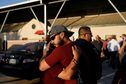 People hug as they react a day after a gunman killed 19 children and two teachers at Robb Elementary School, at Uvalde County Fairplex Arena, in Uvalde, Texas, U.S. May 25, 2022. REUTERS/Marco Bello