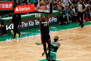 May 29, 2023; Boston, Massachusetts, USA; Miami Heat forward Jimmy Butler (22) dunks against Boston Celtics guard Jaylen Brown (7) during the fourth quarter of game seven of the Eastern Conference Finals for the 2023 NBA playoffs at TD Garden. Mandatory Credit: Winslow Townson-USA TODAY Sports