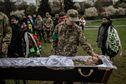 Hlib Kihitov, 21, pays his final respects to his twin brother, Ehor Kihitov, 21, a Ukrainian soldier who was killed this month, during his funeral in Lviv, Ukraine, April 26, 2022. Kihitov was killed along with nearly two dozen of his fellow soldiers in an artillery strike in the town of Popasna in the eastern Luhansk region. (Finbarr O'Reilly/The New York Times)