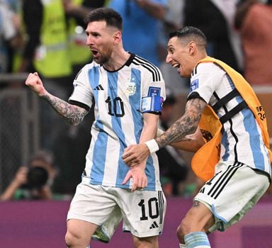 Argentina's forward #10 Lionel Messi (L) celebrates with Argentina's midfielder #11 Angel Di Maria after he scored his team's third goal during the Qatar 2022 World Cup final football match between Argentina and France at Lusail Stadium in Lusail, north of Doha on December 18, 2022. (Photo by Kirill KUDRYAVTSEV / AFP)