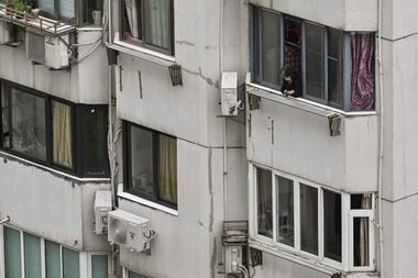 A woman at a residence in Shanghai during the lockdown in Jing'an District on April 23 