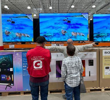 Shoppers consider big-screen televisions in a Costco warehouse Tuesday, Nov. 14, 2023, in Thornton, Colo. According to a raft of polls and surveys, most Americans hold a glum view of the economy. (AP Photo/David Zalubowski)