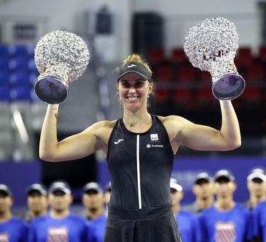 Brazil's Beatriz Haddad Maia poses with the winner's trophies after winning the women's singles final match and doubles final match at the Zhuhai Elite Trophy tennis tournament in Zhuhai, in south China's Guangdong province on October 29, 2023. (Photo by AFP) / China OUT