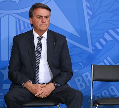 Brazilian President Jair Bolsonaro attends an act in defense of freedom of expression at Planalto Palace in Brasilia, on April 27, 2022. - Brazilian President Jair Bolsonaro defended his decision to grant a pardon to a controversial ally convicted of attacking democratic institutions, saying "I free people who are innocent." The far-right president has come in for criticism since pardoning Congressman Daniel Silveira, a day after the Supreme Court sentenced the 39-year-old lawmaker to eight years and nine months in prison for his role leading a movement calling for the court to be overthrown. (Photo by EVARISTO SA / AFP)