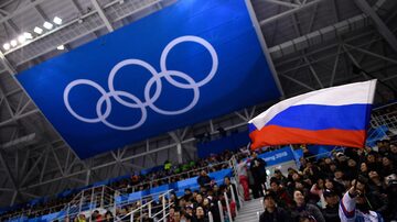 (FILES) A spectator waves the Russia flag during the men's preliminary round ice hockey match between the Olympic Athletes from Russia and Slovenia during the Pyeongchang 2018 Winter Olympic Games at the Gangneung Hockey Centre in Gangneung on February 16, 2018. Olympic chiefs announced on March 19, 2024 that Russian and Belarusian athletes competing in this summer's Paris Games under a neutral flag will not be able to take part in the opening ceremony. Neutral athletes from either country "will not participate in the parade of delegations and teams during the opening ceremony since they are individual athletes", IOC director James McCloud said after an executive board meeting of the International Olympic Committee in Lausanne. (Photo by Brendan Smialowski / AFP)