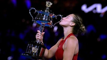 Aryna Sabalenka of Belarus kisses the Daphne Akhurst Memorial Cup after defeating Zheng Qinwen of China in the women's singles final at the Australian Open tennis championships at Melbourne Park, Melbourne, Australia, Saturday, Jan. 27, 2024. (AP Photo/Andy Wong)