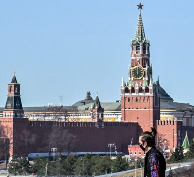 A pedestrian walks on a bridge near the Kremlin in central Moscow on March 22, 2022. (Photo by AFP)