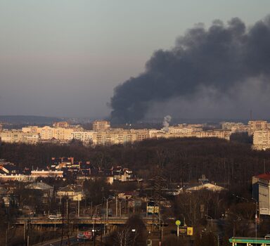 Smoke rises above buildings near Lviv airport, as Russia's invasion of Ukraine continues, in Lviv, Ukraine, March 18, 2022. REUTERS/Roman Baluk