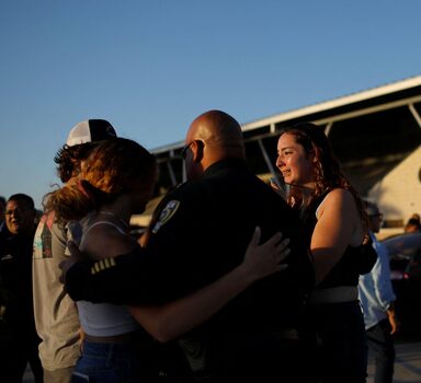 People hug as they react a day after a gunman killed 19 children and two teachers at Robb Elementary School, at Uvalde County Fairplex Arena, in Uvalde, Texas, U.S. May 25, 2022. REUTERS/Marco Bello