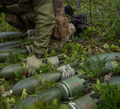 A Ukrainian serviceman prepares to fire a mortar toward Russian positions in the east Kharkiv region, Ukraine, Tuesday, May 17, 2022. (AP Photo/Bernat Armangue)