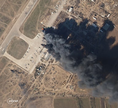 This Planet Labs satellite image taken on March 15, 2022 and released on March 16, 2022 shows Kherson airbase on fire after an alleged airstrike against Russian forces occupying the base. (Photo by Planet Labs PBC / AFP) / RESTRICTED TO EDITORIAL USE - MANDATORY CREDIT "AFP PHOTO / PLANET LABS PBC " - NO MARKETING - NO ADVERTISING CAMPAIGNS - DISTRIBUTED AS A SERVICE TO CLIENTS