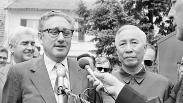 FILE - Henry Kissinger, left, President Richard Nixon's national security adviser, and Le Duc Tho, member of Hanoi's Politburo, are shown outside a suburban house at Gif Sur Yvette in Paris, June 13, 1973, after a negotiation session, as Kissinger announced that they will later initial an agreement intended to tighten enforcement of the Vietnam Peace Agreement. Kissinger, the diplomat with the thick glasses and gravelly voice who dominated foreign policy as the United States extricated itself from Vietnam and broke down barriers with China, died Wednesday, Nov. 29, 2023. He was 100. (AP Photo/Michel Lipchitz, File)