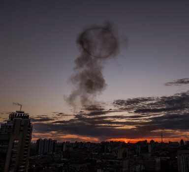 Smoke rises across the Kyiv skyline from the site of a missile strike in Ukraine, on Thursday, April 28, 2022. At least two Russian missiles struck central Kyiv on Thursday evening, one hitting an apartment building and the other falling on a factory across the street. (Daniel Berehulak/The New York Times)