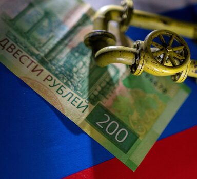 A model of the natural gas pipeline is placed on Russian Rouble banknote and a flag in this illustration taken, March 23, 2022.