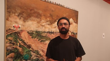 O pintor Jaime Lauriano e sua "releitura" de Pedro Américo. Foto: Alex Silva