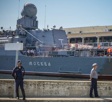 (FILES) In this file photo taken on August 3, 2013 Cuban police stand watch as the "Moskva" Russian guided missile cruiser moors at Havana's harbour. - The Moskva, a Russian warship in the Black Sea, was "seriously damaged" by an ammunition explosion, Russian state media said on April 14, 2022. (Photo by Adalberto ROQUE / AFP)